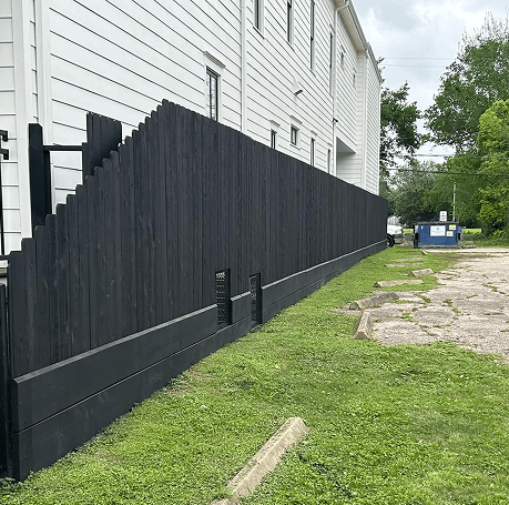 Black-stained wood privacy fence along a Houston property exterior — completed installation by Jorge Torres Fence