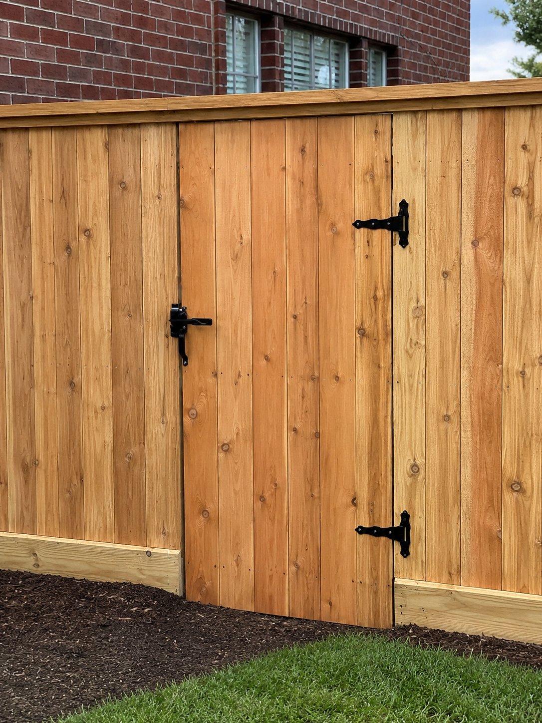 Cedar wood privacy fence gate with black hardware — custom wood gate by Jorge Torres Fence, Houston