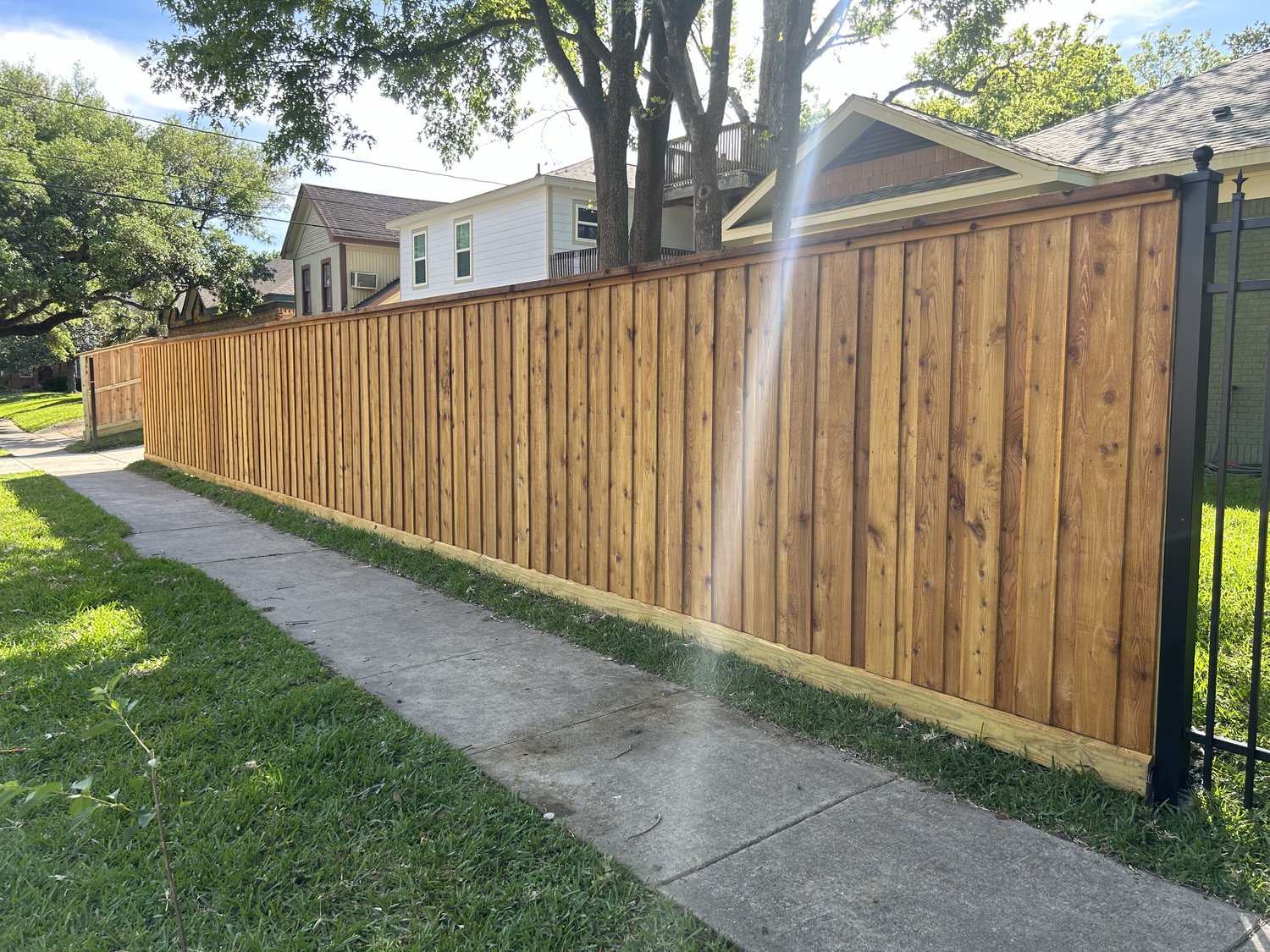 Cedar board-on-board fence with cap trim along a sidewalk — Jorge Torres Fence, Houston