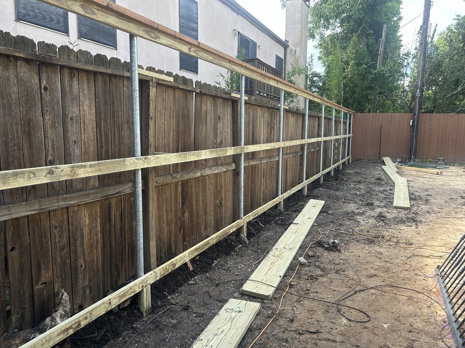 Fence replacement in progress with new galvanized posts — Jorge Torres Fence, Houston